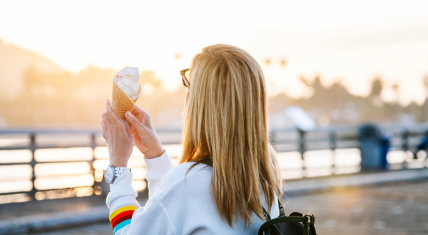 woman eating ice cream on the pier