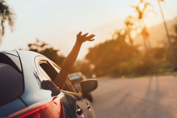 a car with a hand out the window