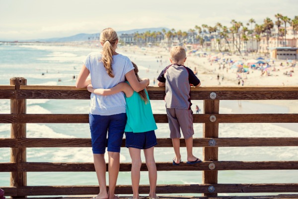 family on the pier looking over the beach