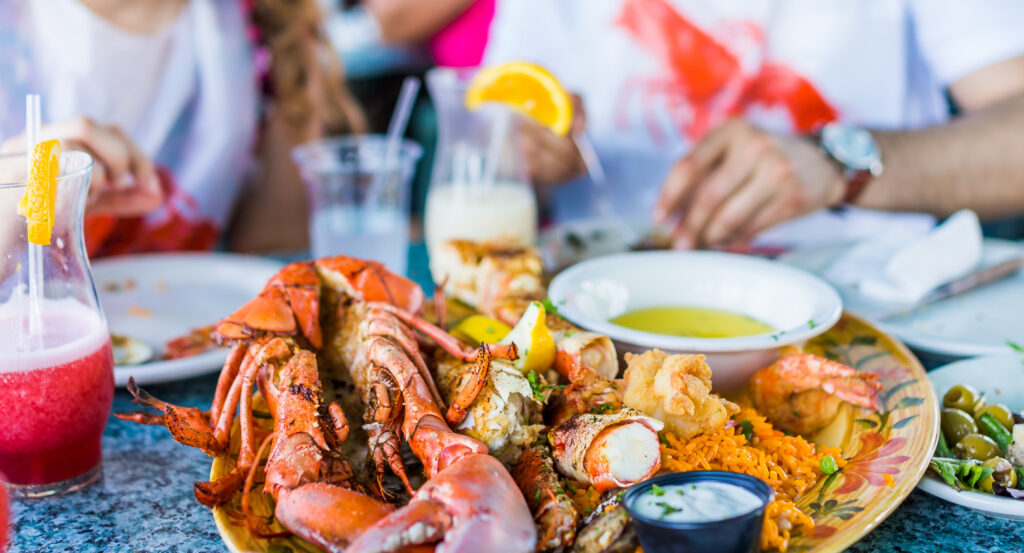 Seafood on a plate, people eating in a restaurant